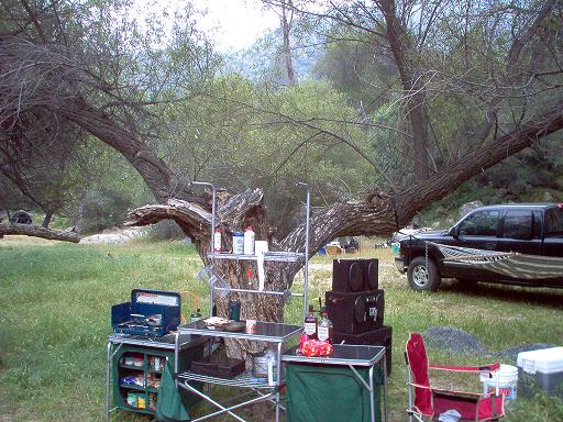 Black pickup truck with hammock strung between it and a tree