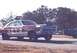 1967 Ford Fairlane - A vintage Ford Fairlane dragster with prominent lettering on its side is captured in motion on a race track.