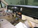 1985 Ford Crown Victoria LTD - The dashboard of a car is disassembled, revealing a complex network of wires and electrical components.