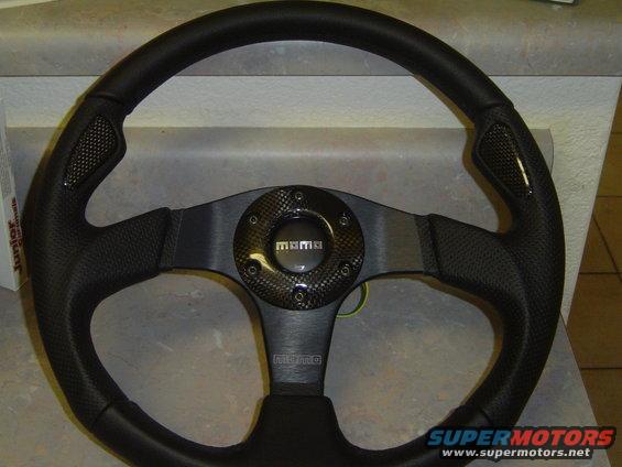 Black leather steering wheel with carbon fiber accents and MOMO branding
