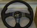 1996 Ford Probe - A close-up view of a black leather MOMO steering wheel with carbon fiber details.