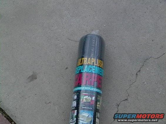 Rolled carpet packaging with text 'ULTRAFLUSH REPLACEMENT CARPET' and images of car interiors