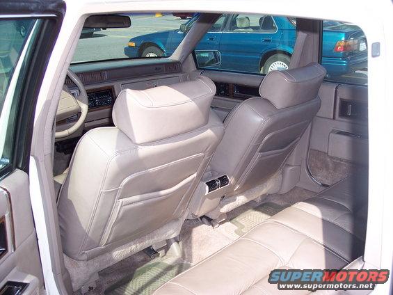 1991 Cadillac DeVille interior, tan leather seats, view from rear passenger side