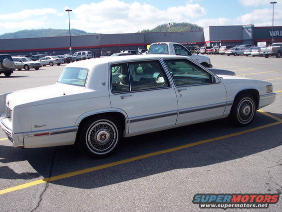 1991 Cadillac DeVille parked in a lot, side view