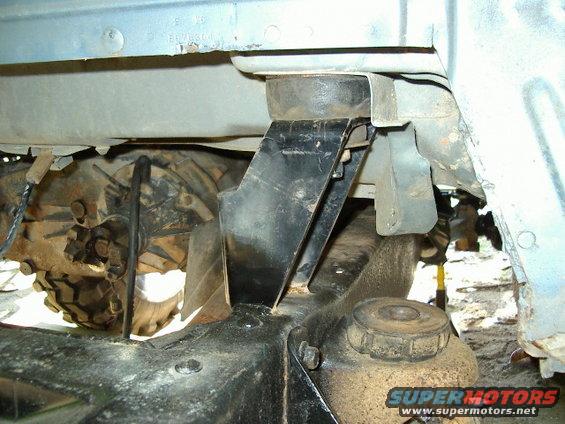 Undercarriage of a vehicle showing a transfer case and suspension components