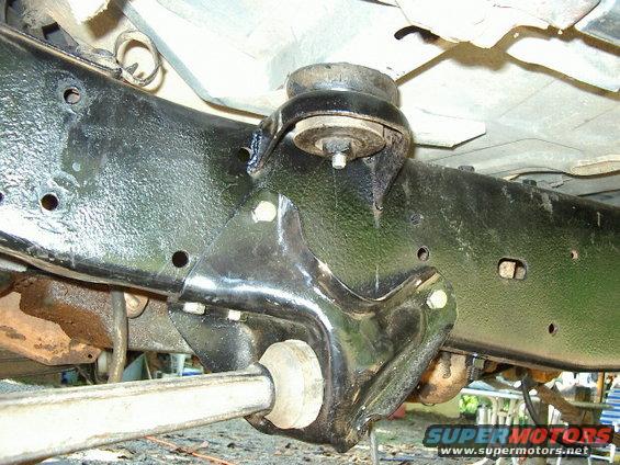 Close-up of vehicle frame with suspension mount and bar