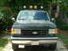 1989 Ford Bronco - This 1989 Ford Bronco features a front-end view with distinctive smiley face lights mounted on its roof rack.
