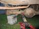 1989 Ford F-150 - Truck's rear axle and suspension components are visible, supported by blocks and a jack.