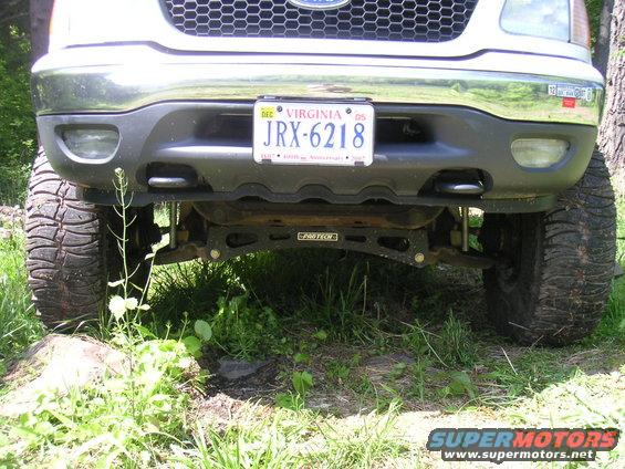 Front view of lifted truck with large tires and Virginia license plate JRX-6218