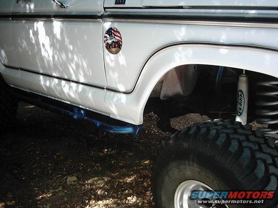 White SUV fender with patriotic decal and off-road tire