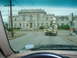 1981 Ford Bronco - A utility truck drives away from the camera on a street with a large building in the background.
