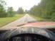 1981 Ford Bronco - Driving down a two-lane road surrounded by trees, with the vehicle's dashboard in the foreground.