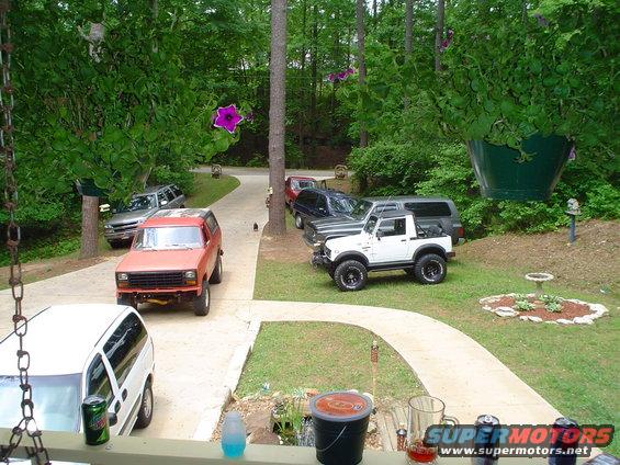 Orange SUV parked on a driveway, front view. It has a black grille and appears to be from the early 1980s