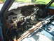 1981 Ford Bronco - The interior of this truck is in disarray, with wires exposed and the dashboard severely damaged.