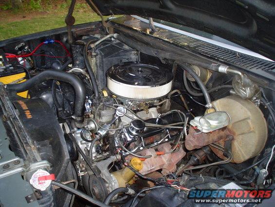 Engine bay with V8 engine, air cleaner, radiator, and brake booster visible
