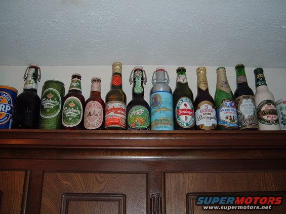 Collection of beer bottles and cans on a shelf