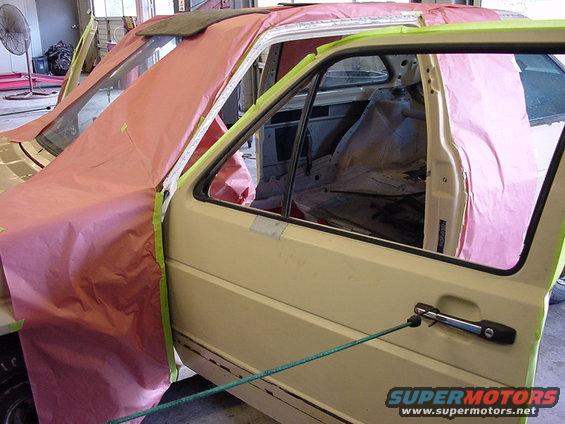 1998 Volkswagen Jetta interior with doors open, covered in masking paper for repair