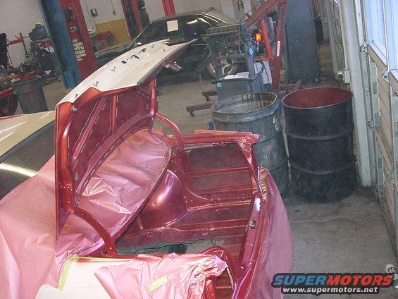 Red car trunk interior with protective plastic sheeting