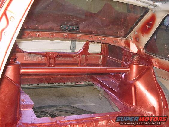 car interior stripped down, showing bare metal and roll cage structure