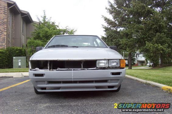 Gray 1983 Volkswagen Scirocco front view, missing grille and bumper components