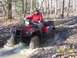 2003 Honda RUBICON - Riding a red 2003 Honda RUBICON ATV through a muddy trail in the woods.