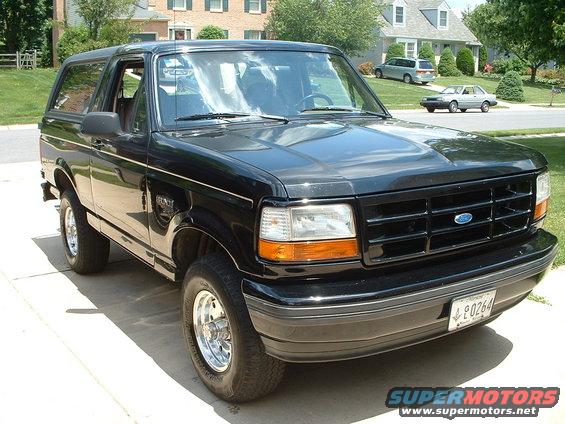 1994 Ford Bronco parked in driveway, front grille and headlights visible