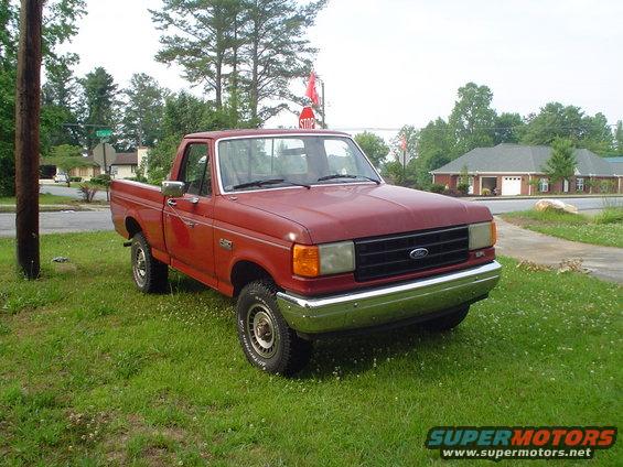 Red pickup truck, 3q-front view. Likely 1987 Ford F-150