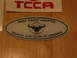 2002 Ford Taurus - A sticker for the Taurus Car Club of America is shown on a wooden background.