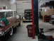 1978 Ford Bronco - A garage scene shows two vintage automobiles and various workshop equipment.