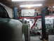 1978 Ford Bronco - Auto repair shop interior with a car body in the foreground and various tools and equipment visible.