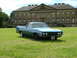 1970 Ford Ranchero - A blue 1970 Ford Ranchero is parked on a lawn in front of a grand estate.