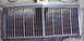 1985 Ford Crown Victoria LTD - A detached chrome grille with a segmented design, likely a replacement part for a vehicle.