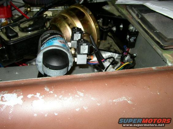 engine bay with brake booster, compressor, and wiring