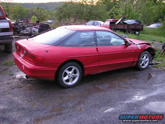 Red coupe with front-end damage, seen from the 3/4 front angle