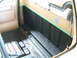 1985 Ford F-150 - The interior of a truck bed is shown after application of a black spray-on liner, with green masking tape along the upper edge.
