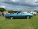 1970 Ford Ranchero - Side view of a blue 1970 Ford Ranchero at an outdoor gathering with tents and people in the background.