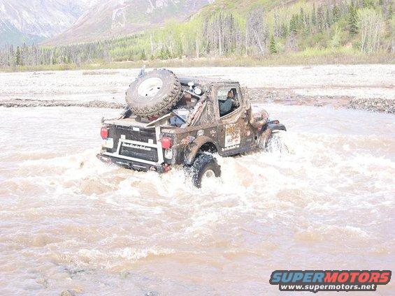 img_2512.jpg Greg attempting another water crossing. This was after his first 2 attempts ended it failer. He would get about 3/4 the way across then the who truck would drop 6" -1' when he tried to give it power to clumb out of the river.