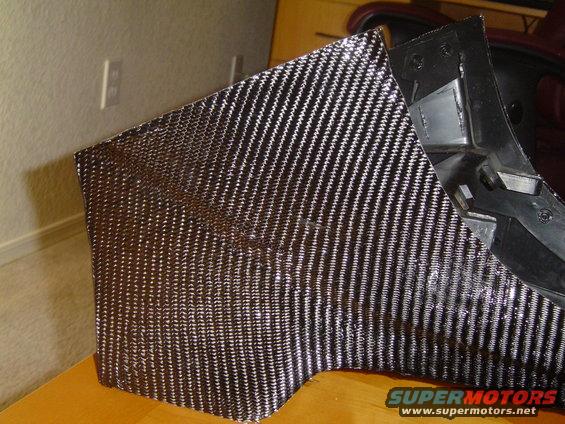Carbon fiber trim piece with black plastic mounting bracket