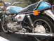 1978 Ford Bronco - A Yamaha motorcycle is loaded into the back of a truck, showing its engine and rear wheel.