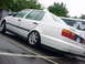 1998 Volkswagen Jetta - A white Volkswagen sedan is parked on a wet surface, with another vehicle a bicycle graphic nearby.