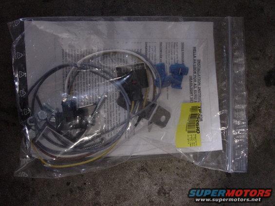 Plastic bag with headlight installation kit, wires, screws, and instructions