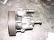1998 Volkswagen Jetta - A power steering pump with a ribbed pulley is shown on a concrete surface.