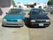 1993 Ford Festiva - Two 1993 Ford Festivas are parked in front of a commercial building.