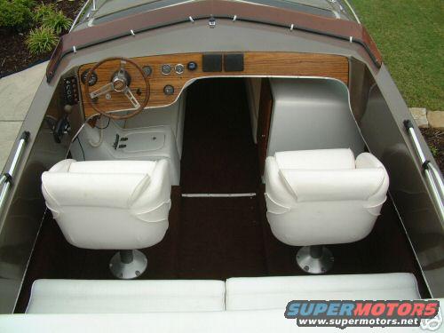 Boat interior with white seats and wood trim dashboard