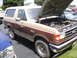 1979 Ford Bronco - This Ford Bronco has its hood open, revealing the engine compartment. Another vehicle is parked to its left.