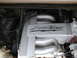 1979 Ford Bronco - Close-up of an engine component with "LIGHTNING" branding, showing exhaust manifolds and wiring.