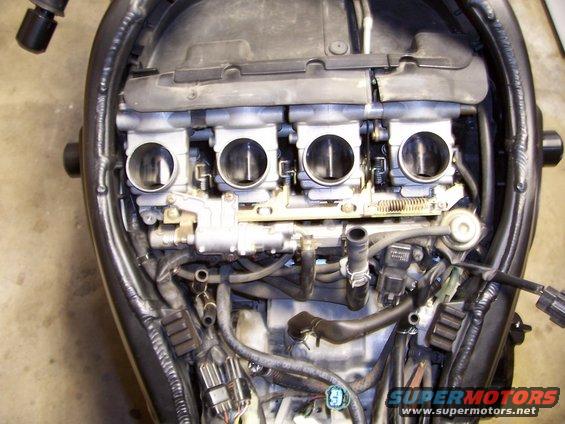 Motorcycle engine intake with four throttle bodies and visible wiring
