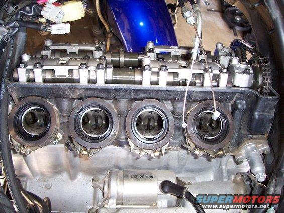 Close-up of motorcycle engine valves and intake ports