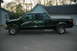 2000 Ford F-350 - Dark green 2000 Ford F-350 Super Duty pickup truck parked in a driveway.