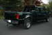 2000 Ford F-350 - This dark green 2000 Ford F-350 pickup truck is shown from the rear, a 4x4 off-road decal on the bed.